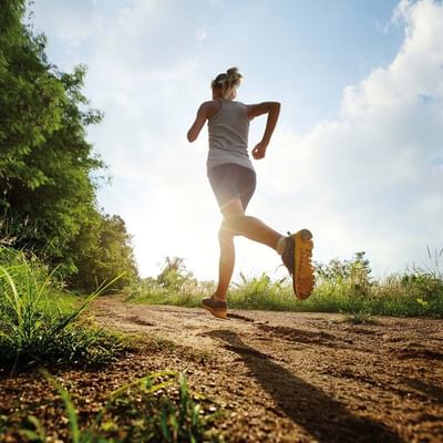 A lady on a natural running track near Falkensteiner Hotels