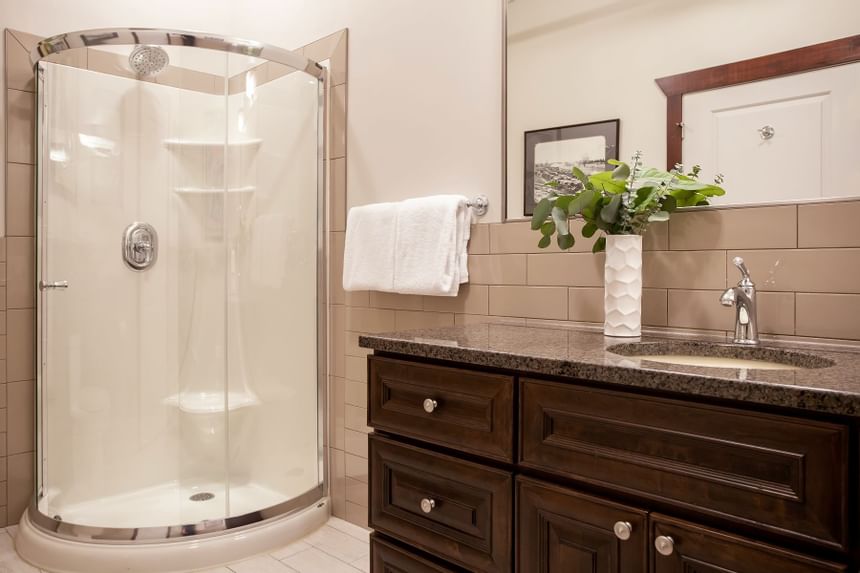 Bathroom vanity & shower in Apartment 407 at Retro Suites Hotel