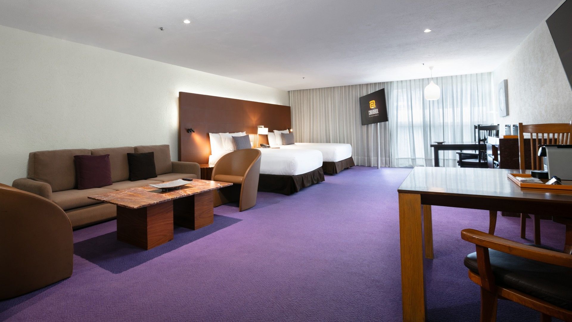 2 Double Junior Suite with two double beds, purple carpet, and a marble coffee table at Camino Real Polanco Mexico