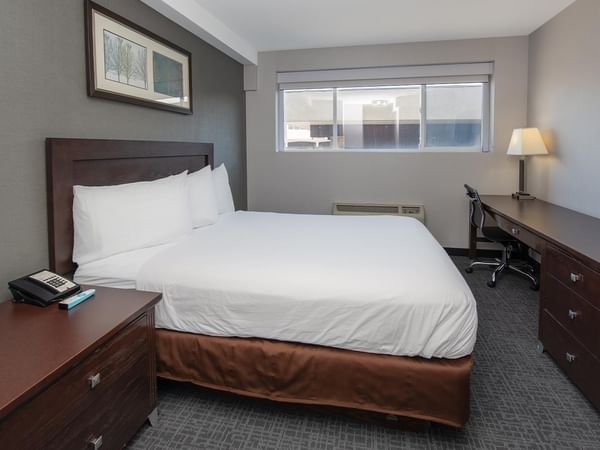 Comfortable bedroom with a double bed, desk, and modern amenities.