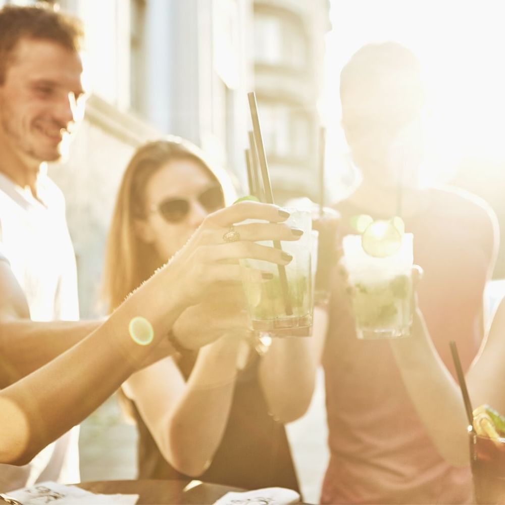 Group of friends toasting glasses at Waikiki Resort Hotel by Sono