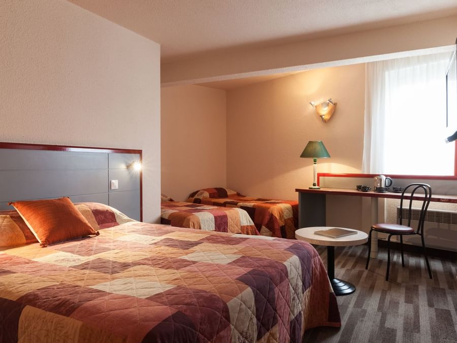 View of bed in Comfort quadruple room at The Originals Hotels