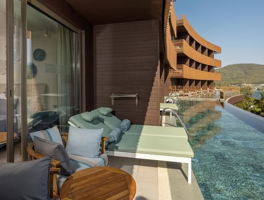 Lounge area by the pool in Swim-up Family Room at Titanic Luxury Collection Bodrum