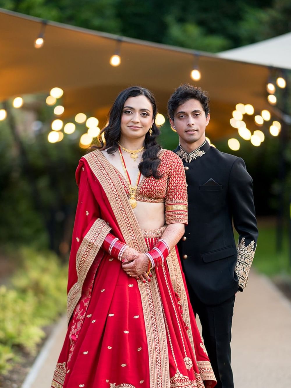 A couple beside the illuminated walkway to the King Suite