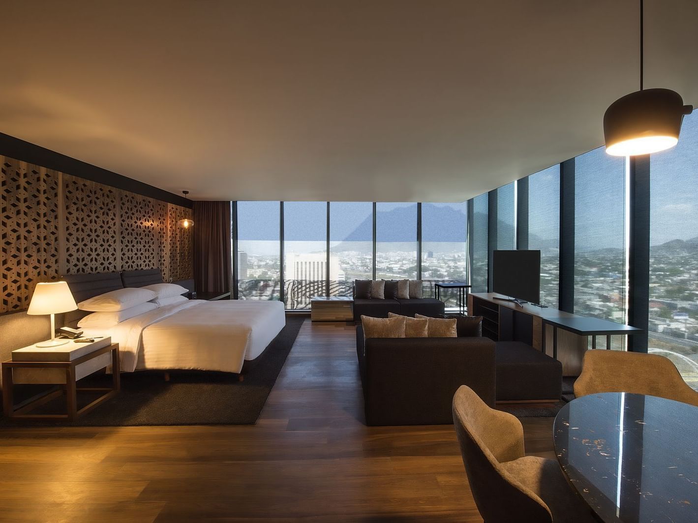 King bed & sofas in Master suite with a city view, La Colección
