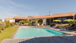 Sunbeds by the outdoor pool at Les Vignes de la Chapelle