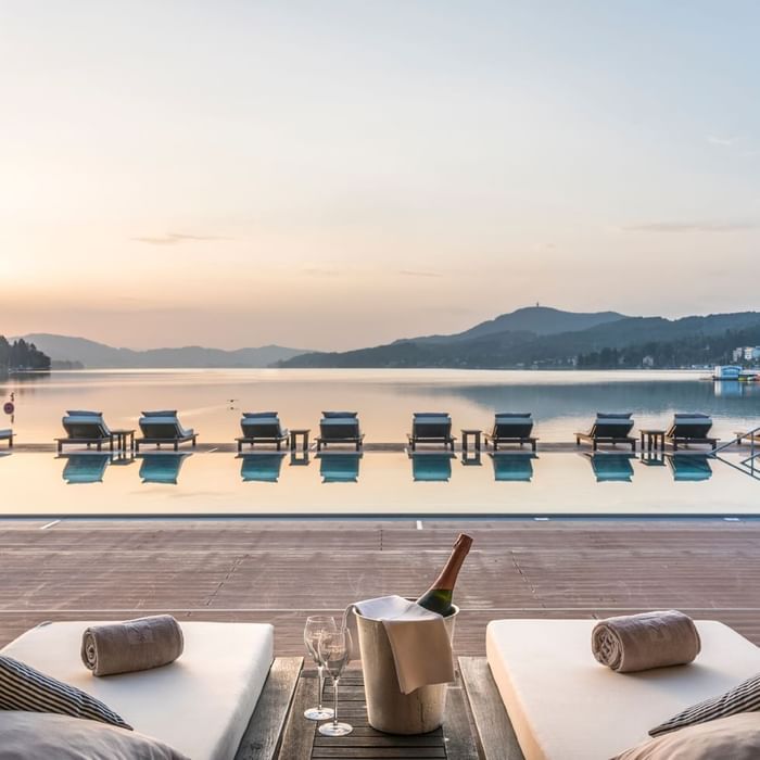 Ariel view of Sunbeds by an outdoor pool at Falkensteiner Schlosshotel Velden