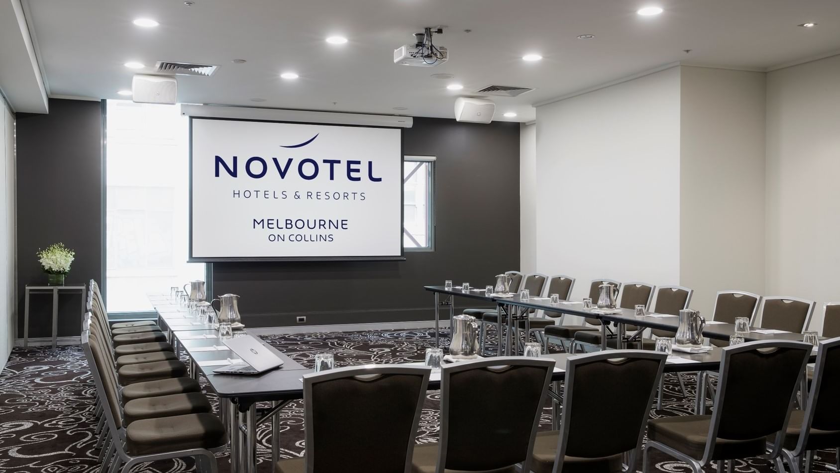 U-shaped table setup for event at Novotel Melbourne on Collins