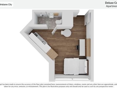 Floor plan of a Deluxe Corner Studio Apartment with a bed, kitchen, and bathroom.