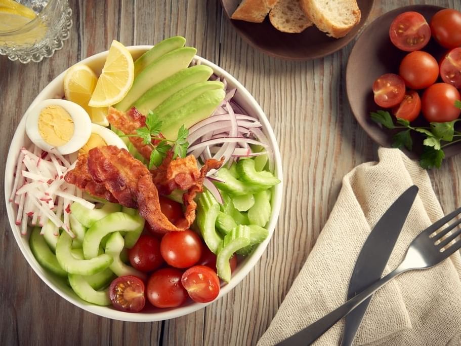 A bowl of cobb salad with toast served at One Hotels