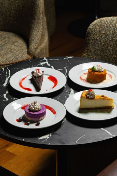 Various dessert dishes served on a table at The Delegate Hotel