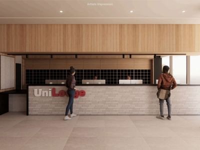 Two guests stand at UniLodge Brisbane City reception in an artist's impression.