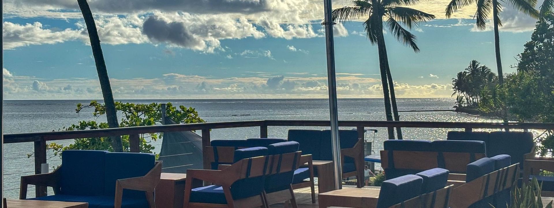 Outdoor seating with ocean view at Sunset Bar, The Naviti Resort in Korolevu, Fiji
