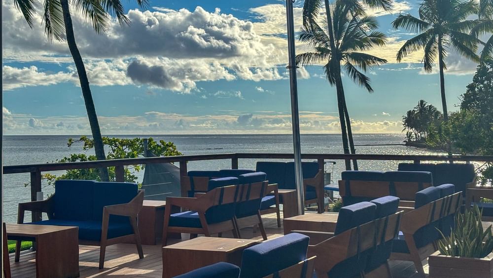 Outdoor seating with ocean view at Sunset Bar, The Naviti Resort in Korolevu, Fiji.