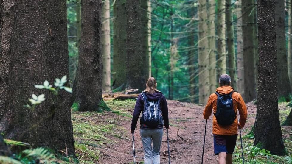 A couple walking in a mountain trail near Falkensteiner Hotels and Residences