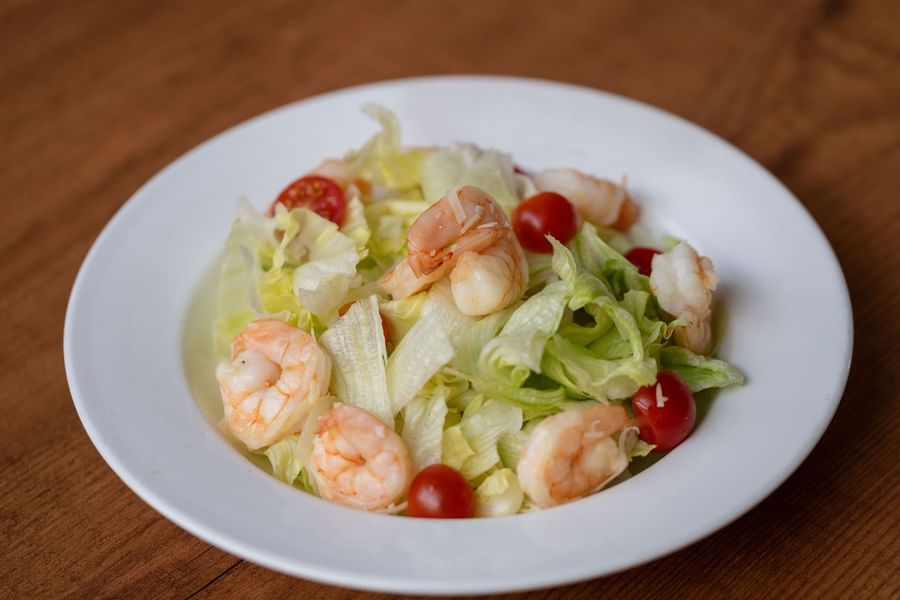 Fresh salad with shrimp, cherry tomatoes, and lettuce served in the Seasons Restaurant at Warwick Hotel Jeddah