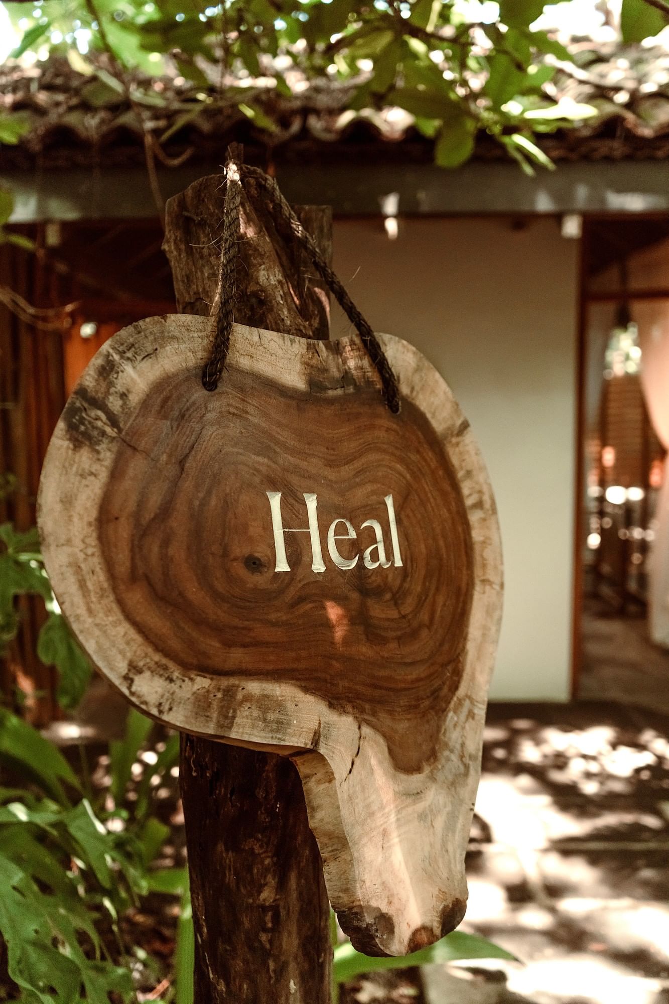 Rustic Heal wooden sign used in Lahari Wellness Center promoting wellness and relaxation journey at Cala Luna Boutique Hotel