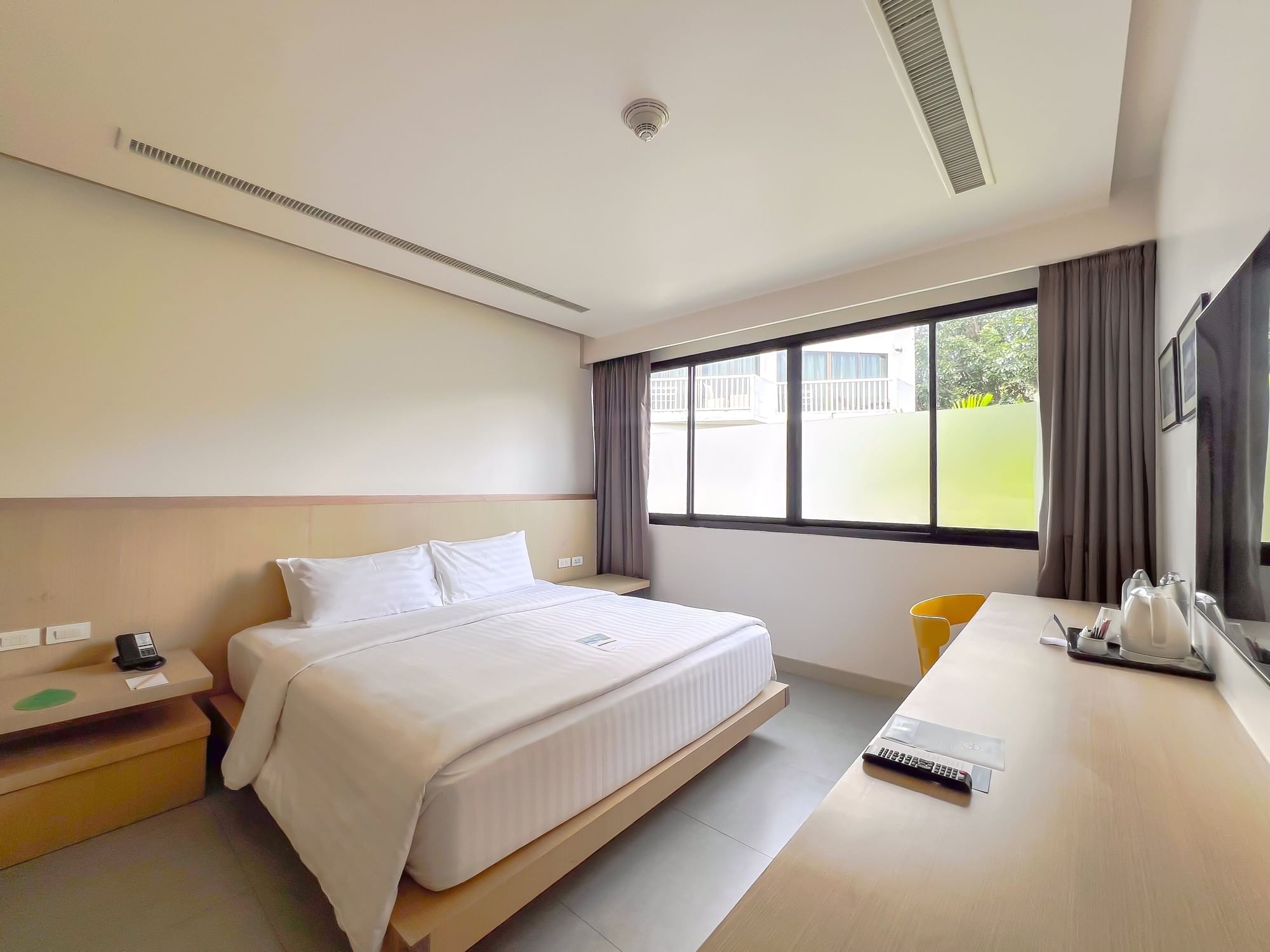 Studio Room at Paradox Phuket featuring a king-size bed, natural daylight, and modern contemporary interiors in Phuket
