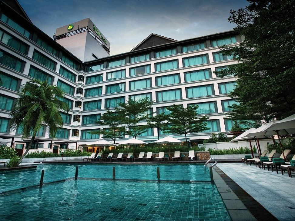 Outdoor swimming pool area with hotel exterior view at MiCasa All Suite Hotel KL