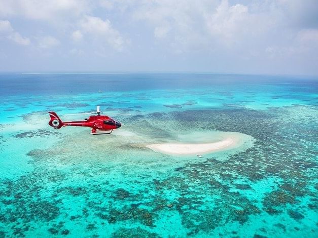 Helicopter flying over Vlasoff Cay near Pullman Port Douglas Sea Temple resort & Spa