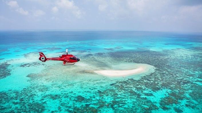 Helicopter flying over Vlasoff Cay near Pullman Port Douglas Sea Temple resort & Spa