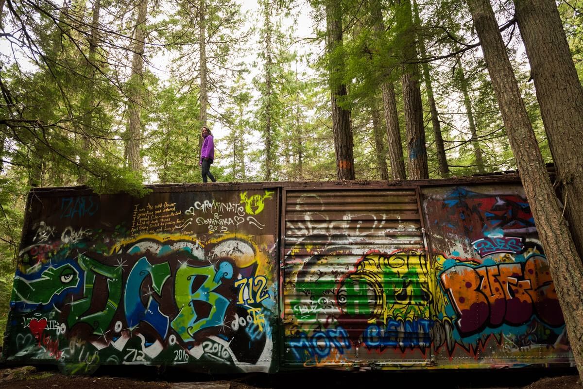 A girl stands on a old truck near Blackcomb Springs Suites