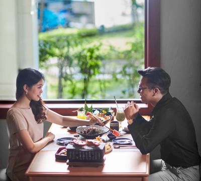 Couple enjoying their meal at Hanoi Daewoo Hotel