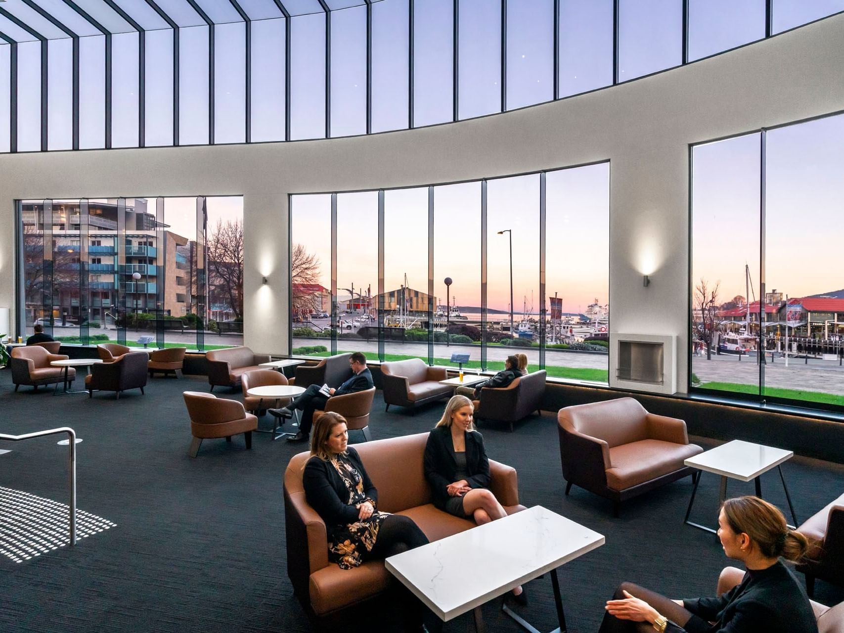 Guests relishing their time in the Atrium lobby at Hotel Grand Chancellor Hobart