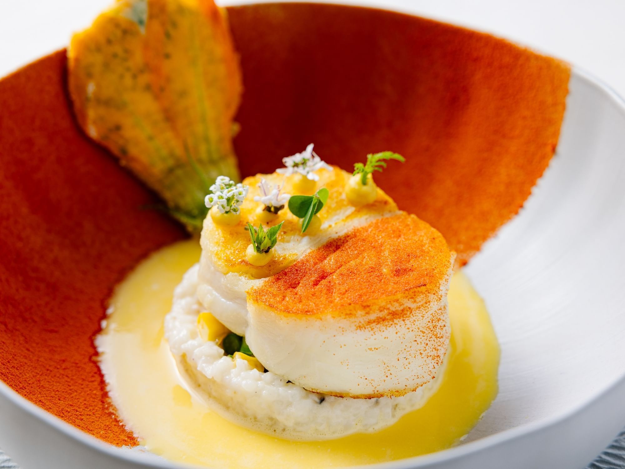 Close-up of a scallop dish served in Herons at The Umstead Hotel and Spa