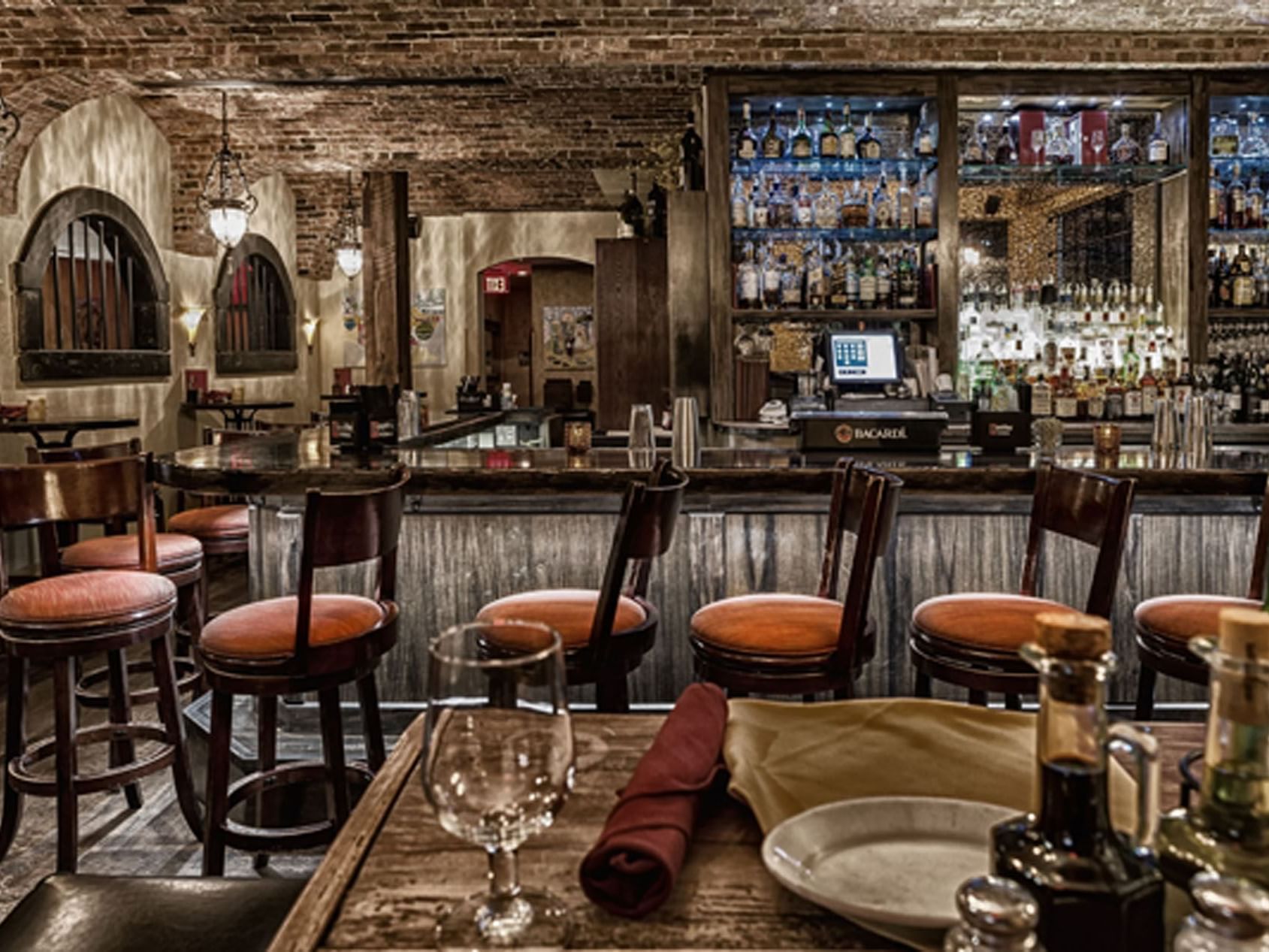 The bar counter with wooden interior in Trattoria Romana Restaurant near Ocean Lodge Boca Raton