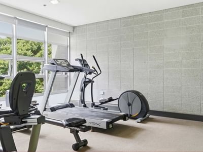 Exercise room with two treadmills and a stationary bike at Student Living Auckland – Anzac.