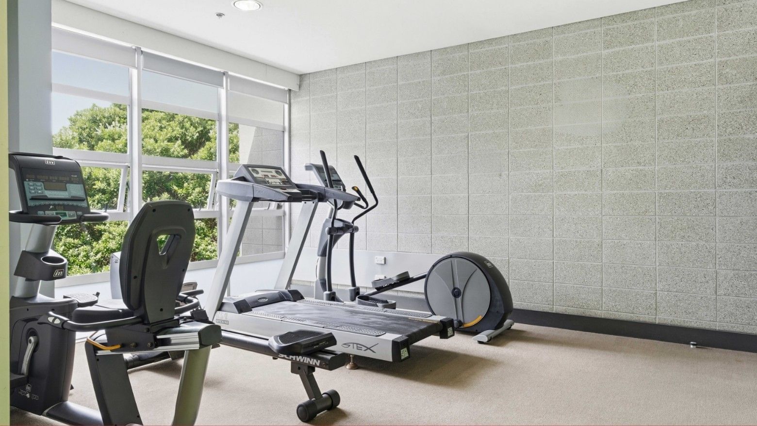 Exercise room with two treadmills and a stationary bike at Student Living Auckland – Anzac.