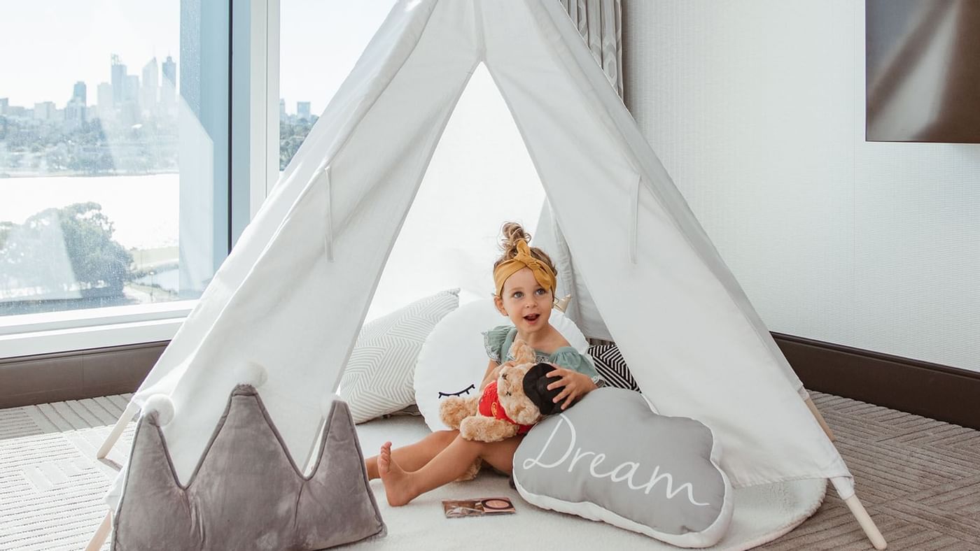A baby inside a tent in Towers Teepee at Crown Hotels