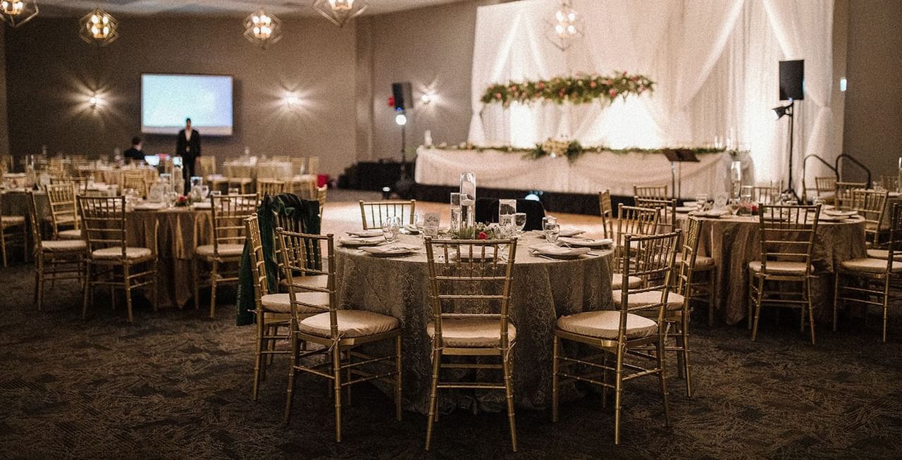 Wedding venue with flowers, table, and chairs