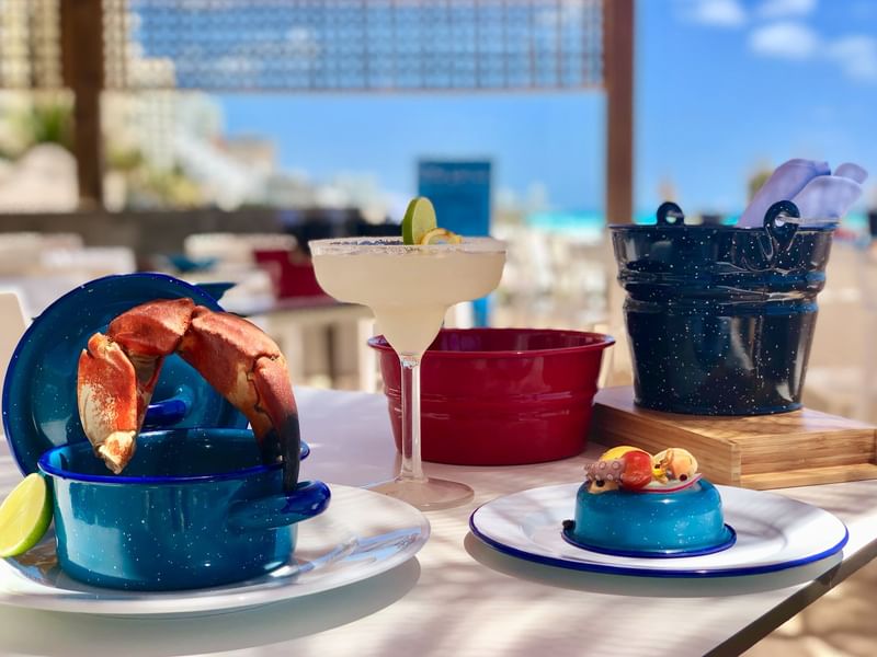 Seafood and beverages served on a table at Live Aqua Resorts and Residence Club