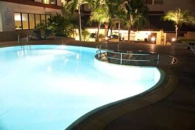 Pool area with illuminated lights at Amora Hotel Chiang Mai