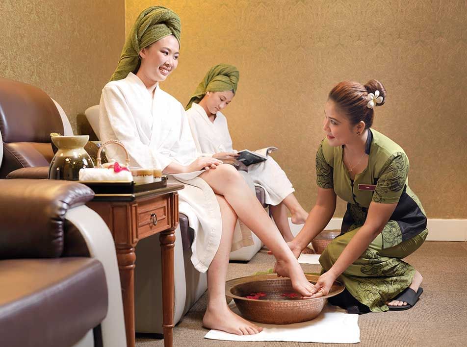 Two ladies enjoy a relaxing foot spa treatment at LexSpa - Grand Lexis Port Dickson