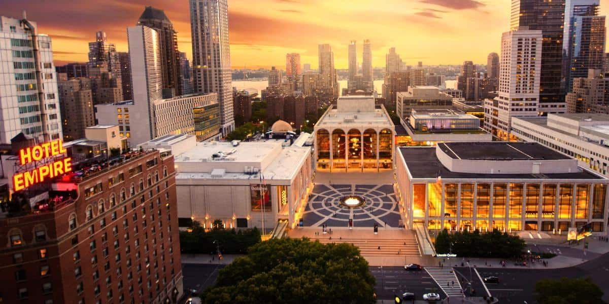 Aerial view of the Hotel Empire building in a cityscape at sunset.