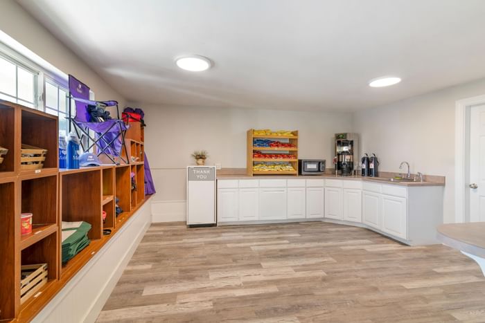 Coffee station with amenities by a shelf with items at Ogunquit Collection