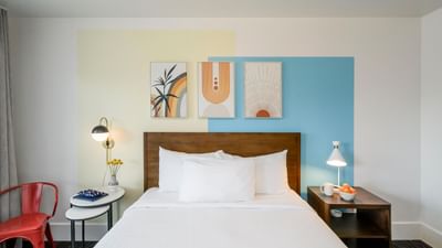 Bed and nightstands with wall art in Superior Queen Room at Becks Motor Lodge San Francisco California