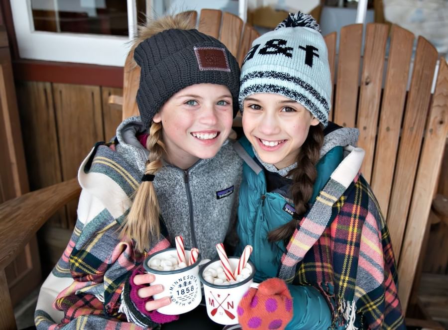 two girls drinking hot chocolate