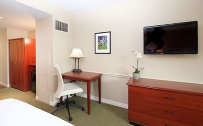 Tv & furniture in a bedroom at Mt. Washington Conference Center