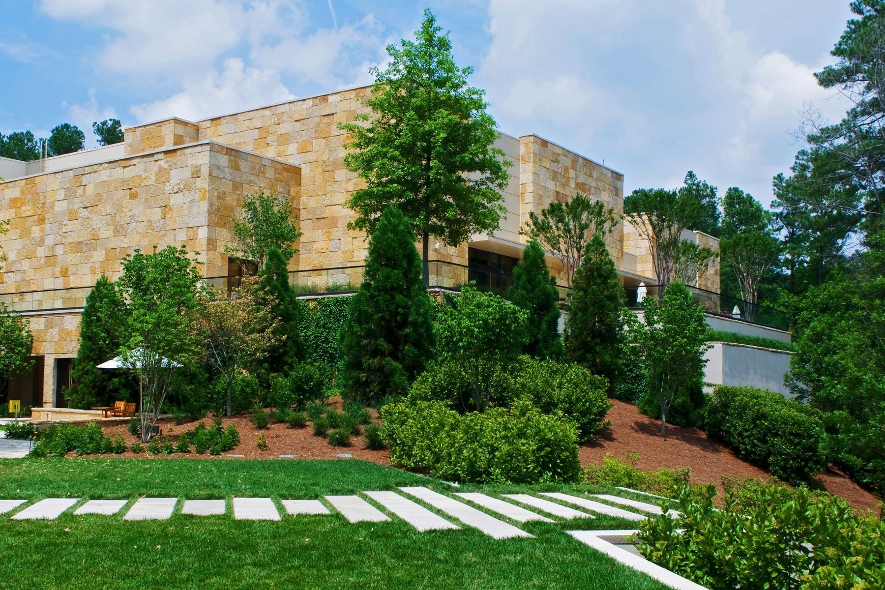 Hotel exterior surrounded by lush greenery at The Umstead Hotel and Spa