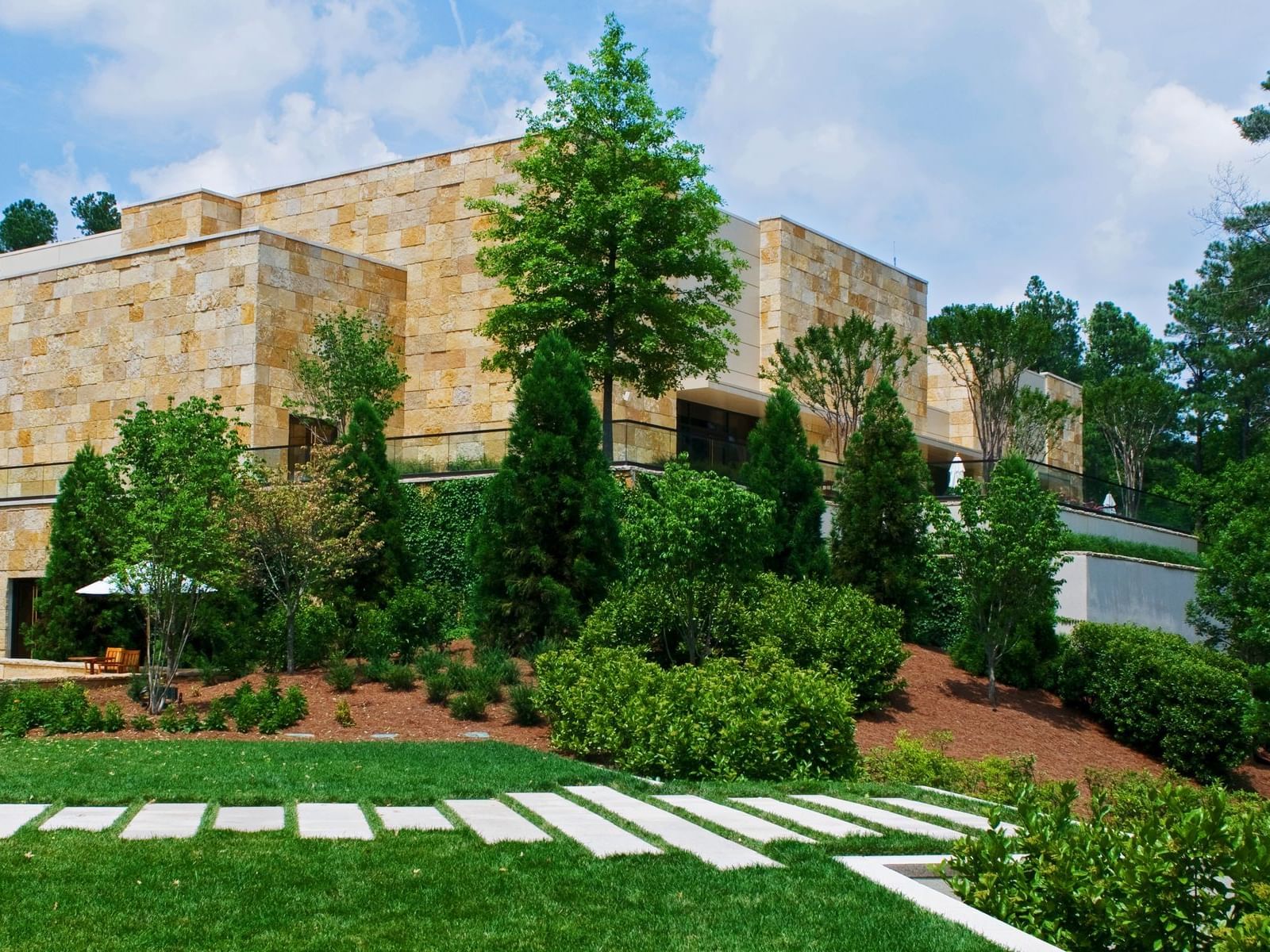Hotel exterior surrounded by lush greenery at The Umstead Hotel and Spa