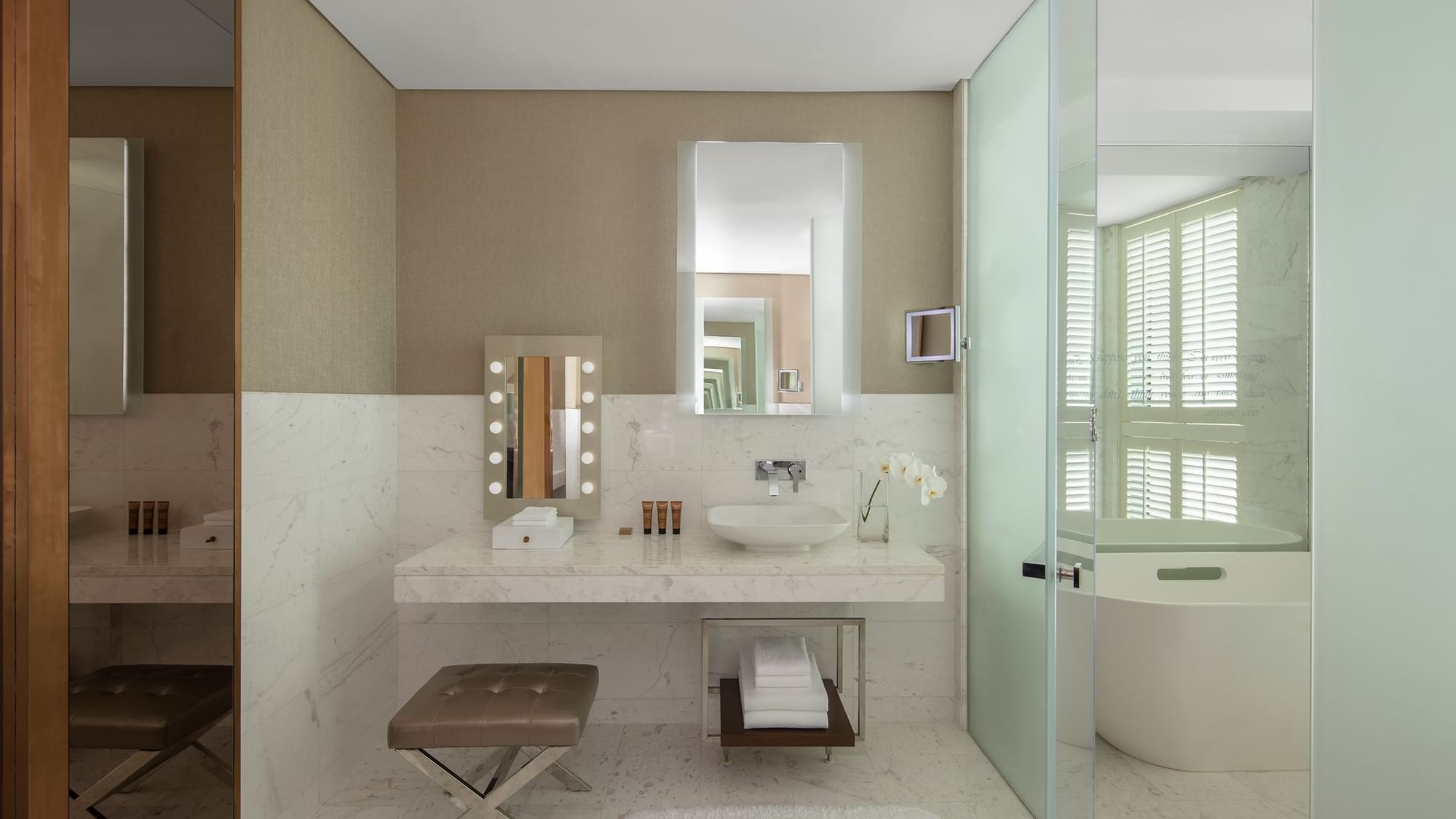 Premier Suite bathroom at Paramount Hotel Dubai features a marble countertop, large mirrors, a bathtub, and elegant decor