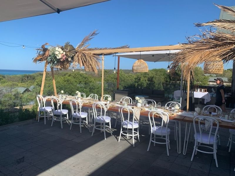 Long table on outdoor balcony for wedding reception