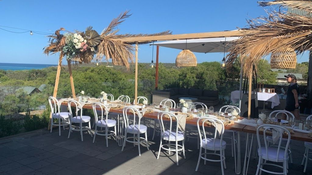 Long table on outdoor balcony for wedding reception