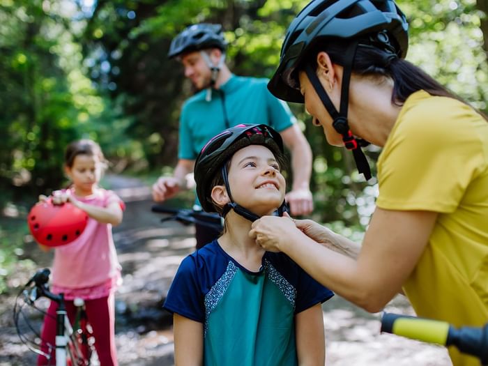 A family biking in the woods