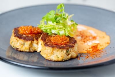 Close-up of cab cakes served with fish eggs & garlic sauce at Stein Eriksen Residences