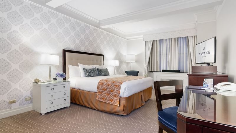 TV & work desk by the bed in Premier Room at Warwick New York